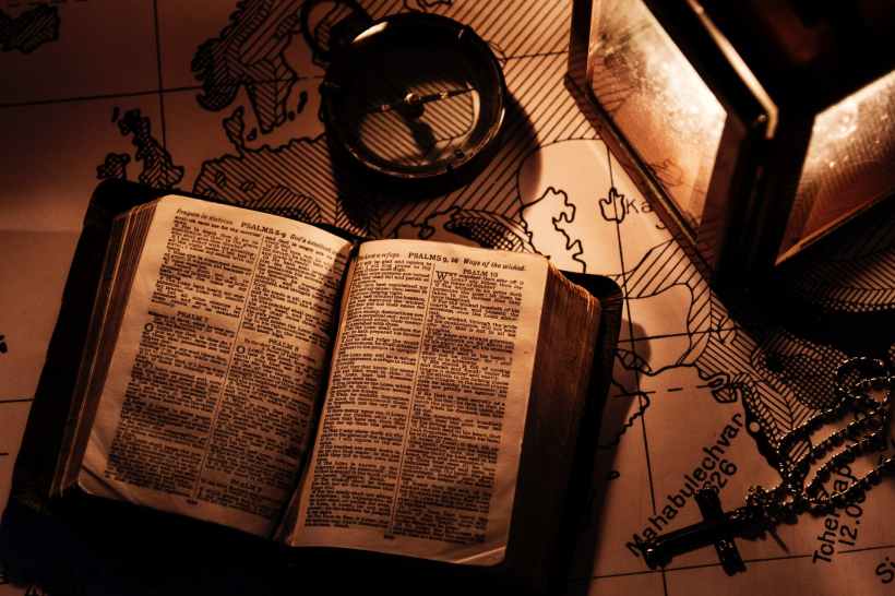 opened bible on wooden surfaca