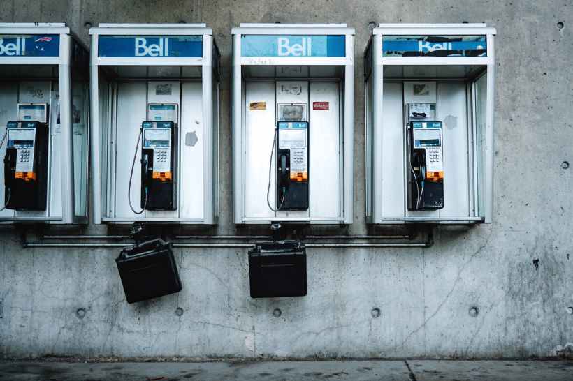 four black and white telephones